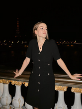 A young lady wears a black dress